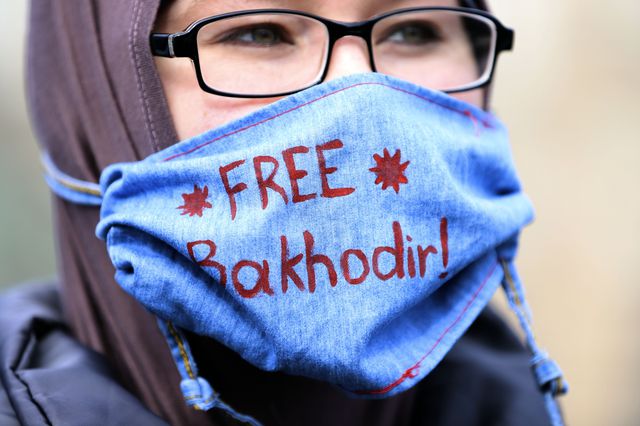 Madina Madjitov wears a mask that reads "Free Bakhodir" during a rally for her husband in April.